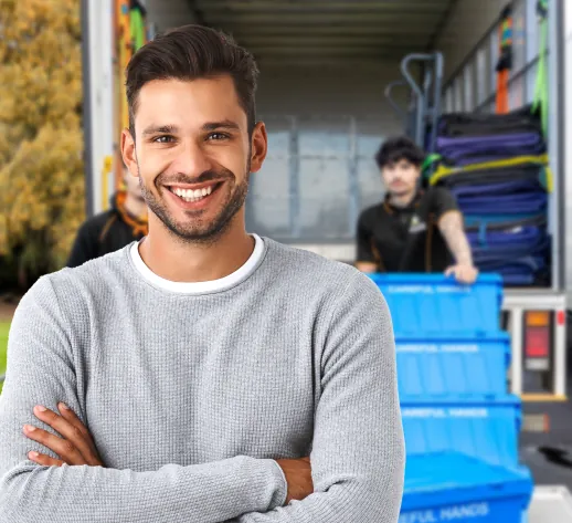 Smiling customer standing in front of a Careful Hands Movers truck